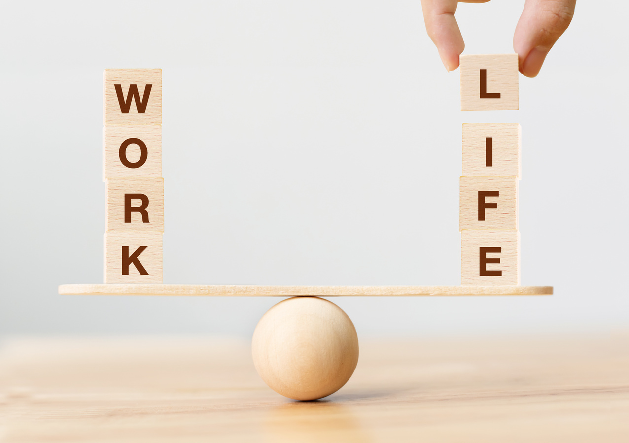 Work life balance concept. Wooden cube block with word WORK and LIFE on seesaw